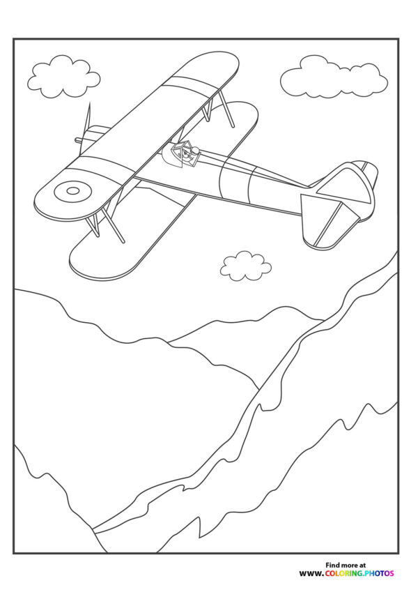 Biplane flying over the mountains