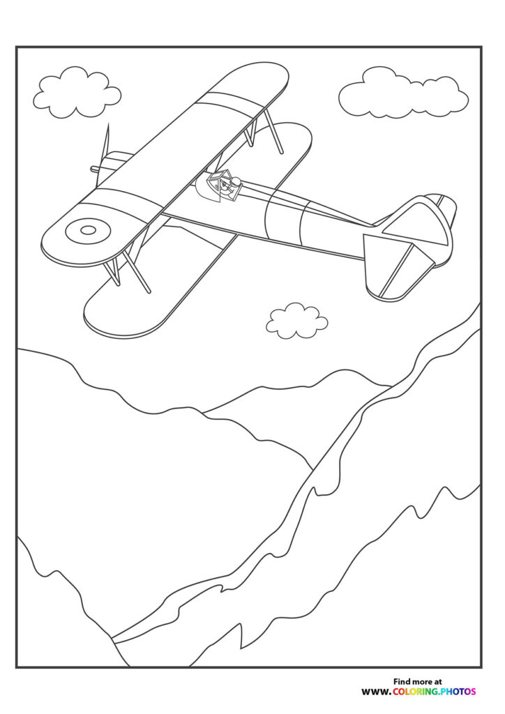 Biplane flying over the mountains