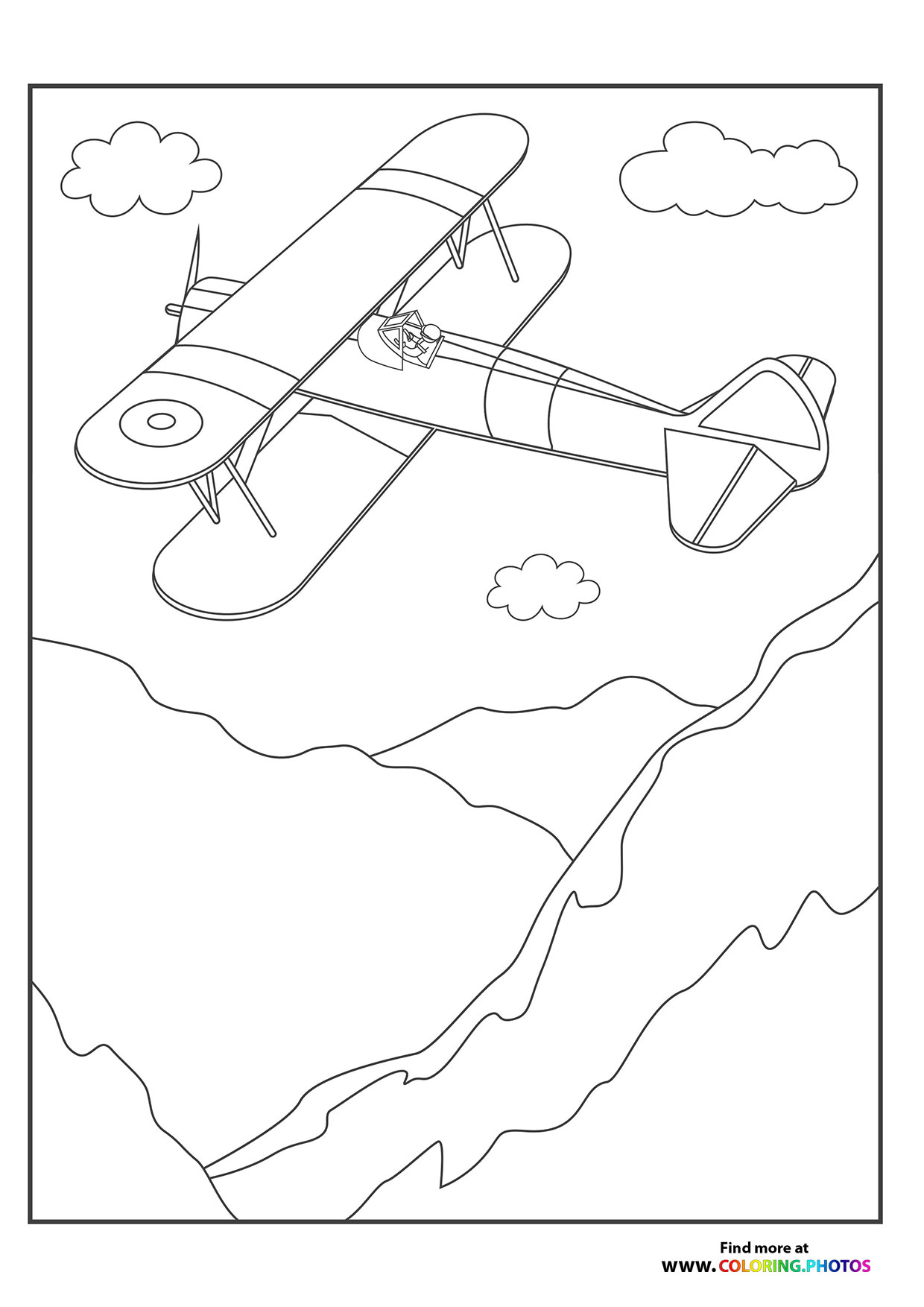 Biplane flying over the mountains