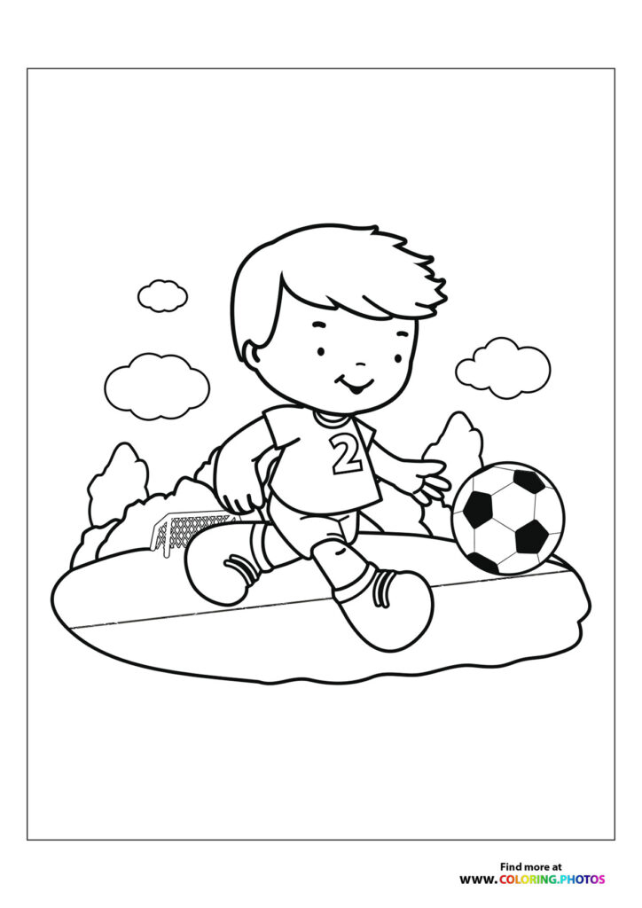 Boy kicking soccer ball