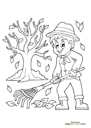 Boy raking autumn leaves