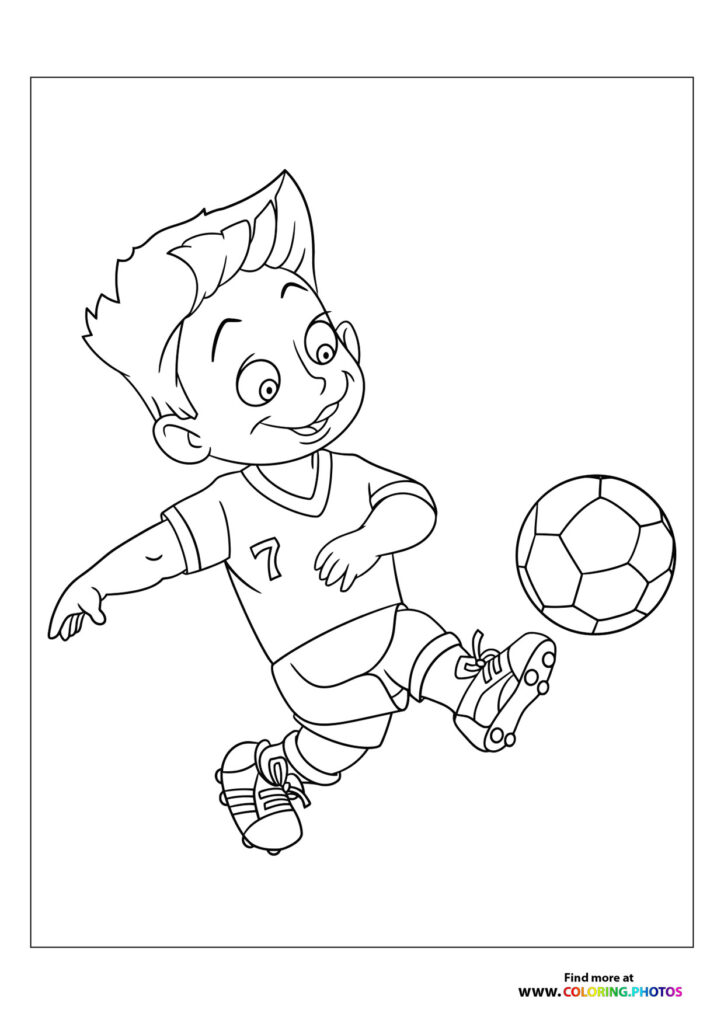 Little boy kicking the football